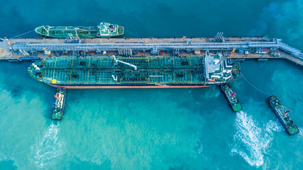 Aerial view super tanker ship anchored at the oil terminal at port.